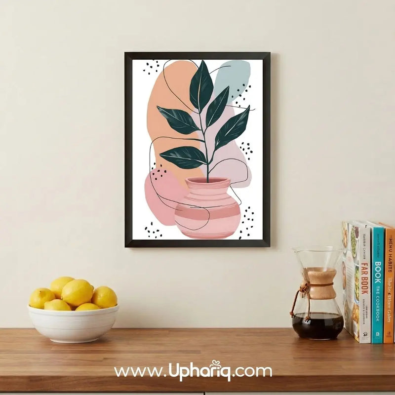 Abstract botanical leaf vase wall art displayed above a wooden console in a modern kitchen with books, coffee brewer, and decorative accents.