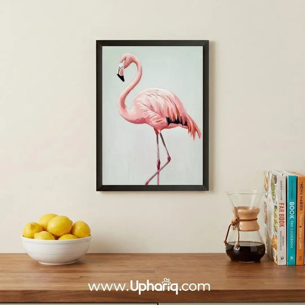 Pink flamingo wall art frame displayed on a living room wall with modern home decor